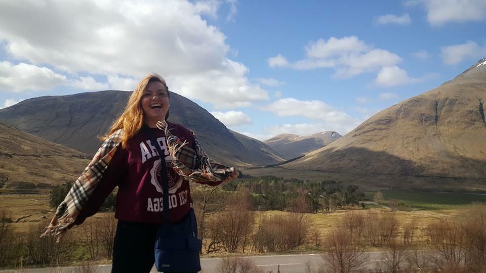 Student in front of rolling hills in Scotland